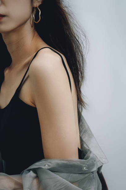 istock Stylish woman with bare back wearing silver earrings 1347806883