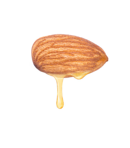 istock almond oil isolated on white background. 1347810583