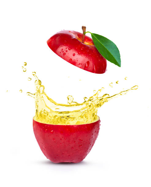 istock Fresh red apple with apple cider vinegar or juice splashing isolated on white background. 1347810610