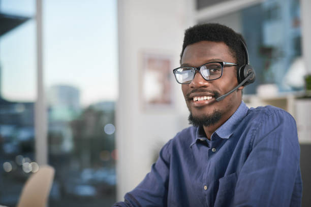 istock Portrait of a young man using a headset in a modern office 1347814895
