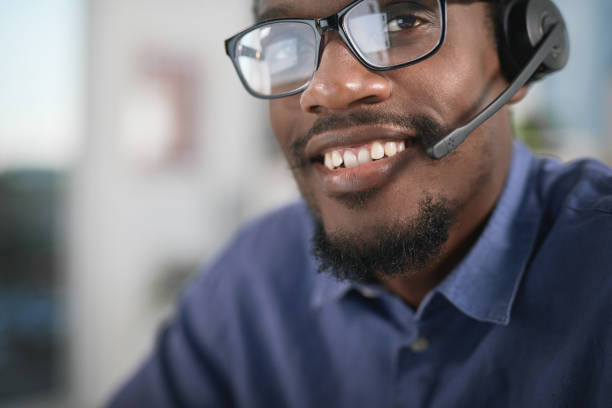 istock Portrait of a young man using a headset in a modern office 1347814905