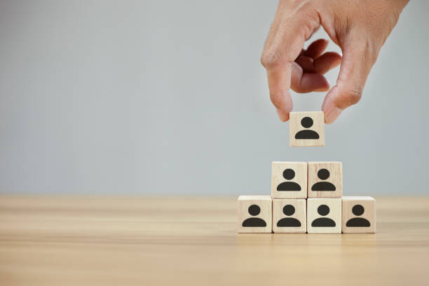 istock Man hands holding cube with many human symbol 1347815965