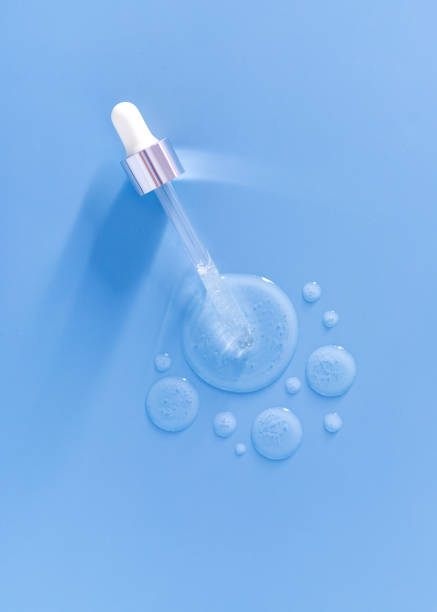 istock pipette drops of serum on blue background 1347818724