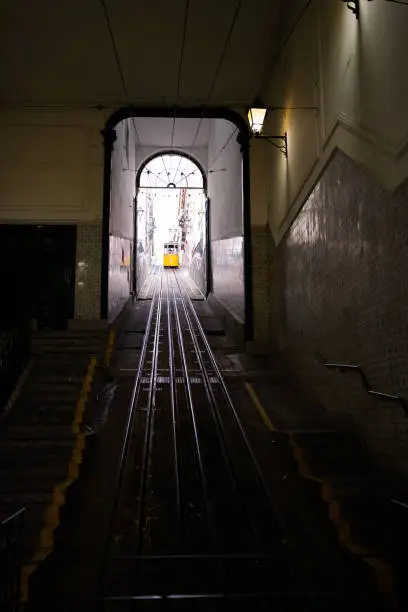 Photo of Vertical photography of a tram coming out of a tunnel on an uphill track