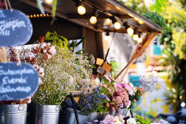 Street market stall full of pots with glowers and plants stock photo