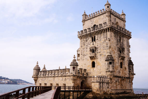 istock Historical sone tower and bridge next to the river in Lisbon 1347822347