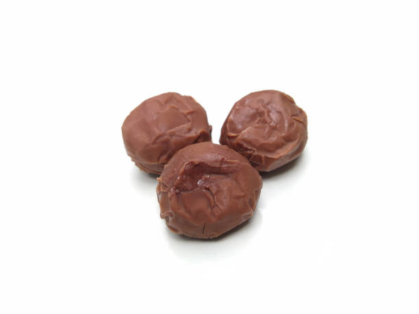 istock sweet chocolate balls isolated on white background, selective focus 1347823676
