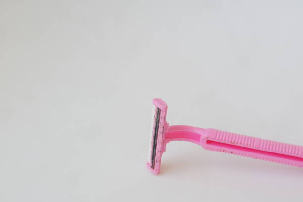 istock used pink beard razor on white isolated background photo 1347825584