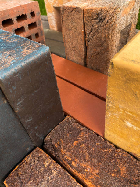 istock Different types of bricks stacked beautifully on green grass 1347826876