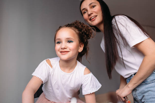 istock mom makes her daughter hair 1347828046