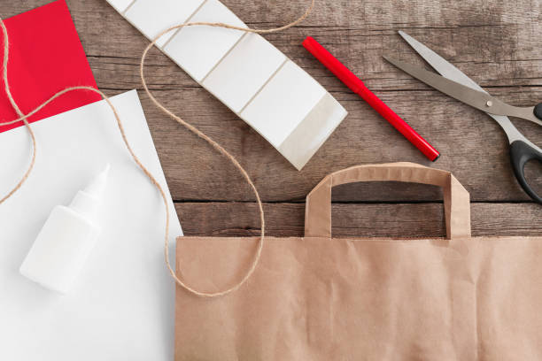 istock Advent calendar for Christmas and New Year. Multi-colored paper, scissors, felt-tip pen, rope, scotch tape, package on a wooden background top view. DIY concept. Step-by-step photo instruction step 1. 1347829058