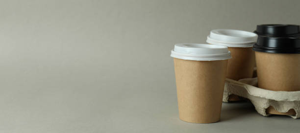istock Cup holder with paper cups on light gray background 1347830297