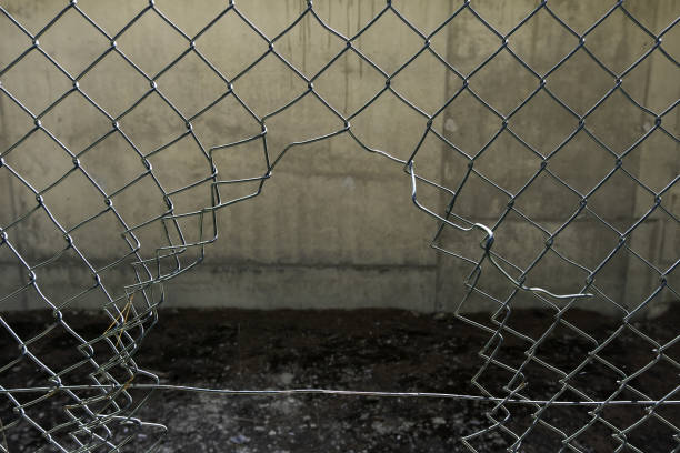 istock Broken metal fence vandalism 1347832424