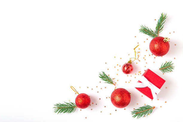 istock Christmas minimal composition. Gift box, fir tree branches, red decorations balls on white background. Christmas, winter, new year concept. Flat lay, top view, copy space 1347836095