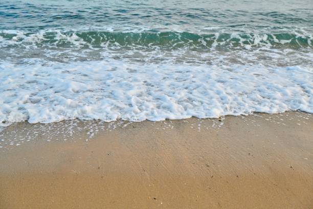 istock Seascape at sunrise, sea background, foam, sand, dawn. 1347836268