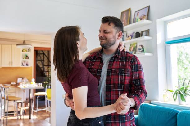 istock Happy romantic middle aged couple dancing at home 1347837234