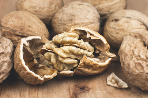 istock Crushed Walnut on the wood background. Close up. 1347837617