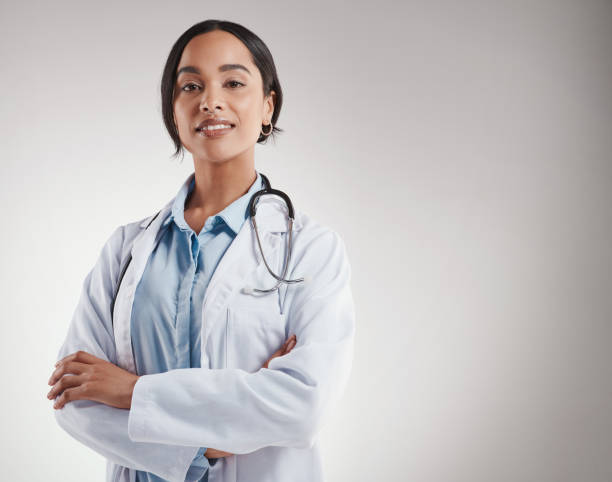 istock Shot of medical practitioner smiling while standing against a grey background 1347838365
