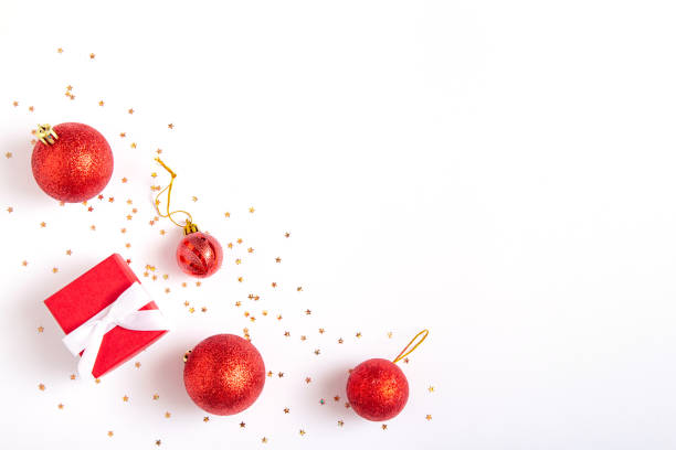 istock Christmas minimal composition. Gift box, red decorations balls on white background. Christmas, winter, new year concept. Flat lay, top view, copy space 1347839776
