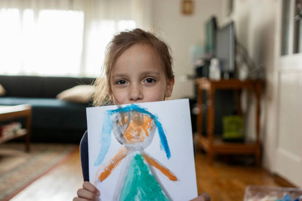 istock Child holding her drawing on a paper 1347840237