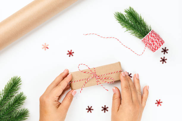 istock topview woman hand hold ready-packed gift box for Christmas night, self-made gift concept 1347840298