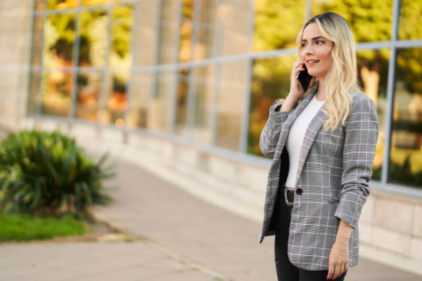 istock business woman using a smart phone. Professional woman using technology 1347840347