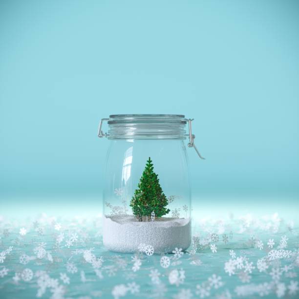 istock Outstanding Christmas tree with gift box present on glass bottle with snowflakes outside blue background. 1347840734