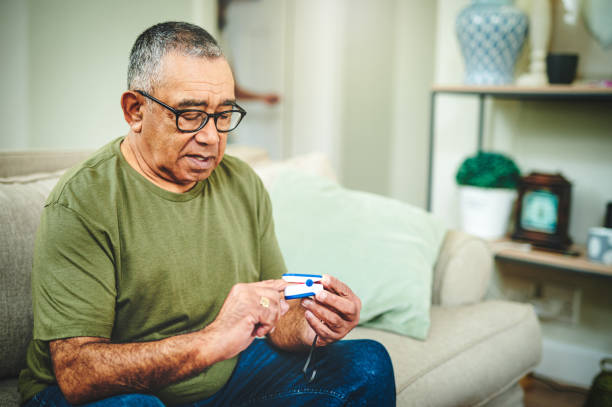 istock Shot of a senior man using a pulse oximeter at home 1347841344