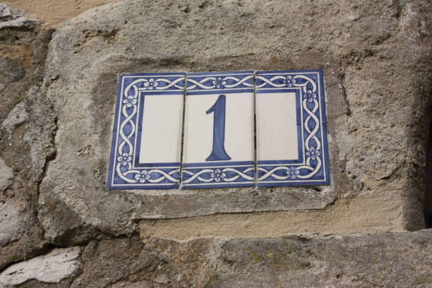 istock Ceramic street number on an old wall Number 1 1347841408