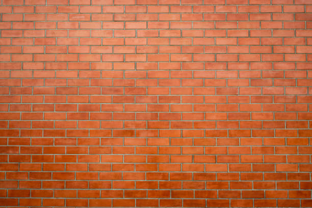 istock Brick wall texture background. Red brick wall wallpaper in vintage style. Orange background. Interior of brick building. Red brickwork. House construction industry background. Loft style house wall. 1347842978