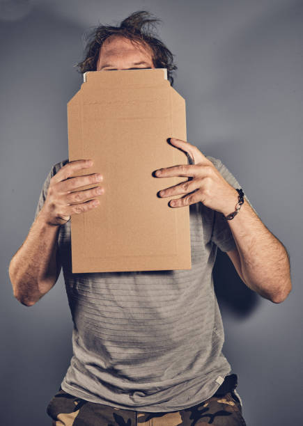 istock Man holding sign in front of head 1347846169
