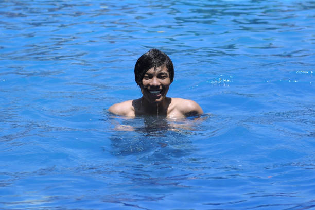 Portrait of man swimming in pool