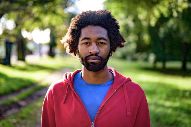 Black athlete portrait outdoors in autumn sunshine