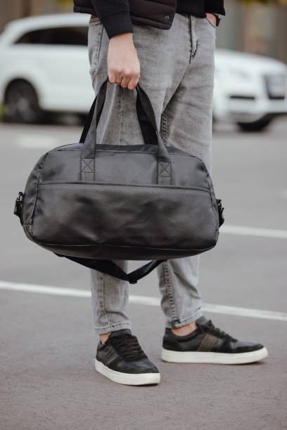 istock Unrecognizable man holding bag in a city 1347850163