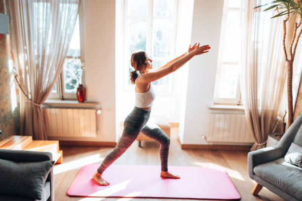 istock woman doing yoga at home 1347851120