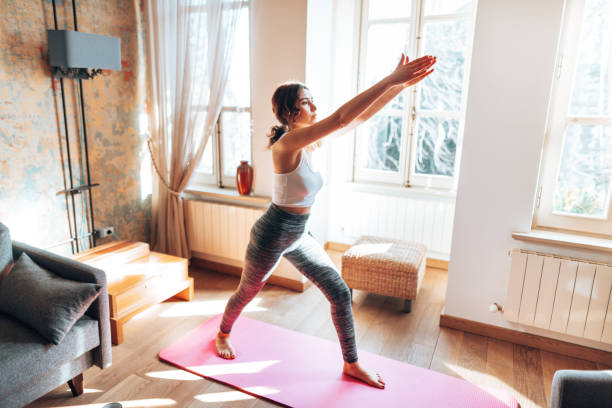 istock woman doing yoga at home 1347851176