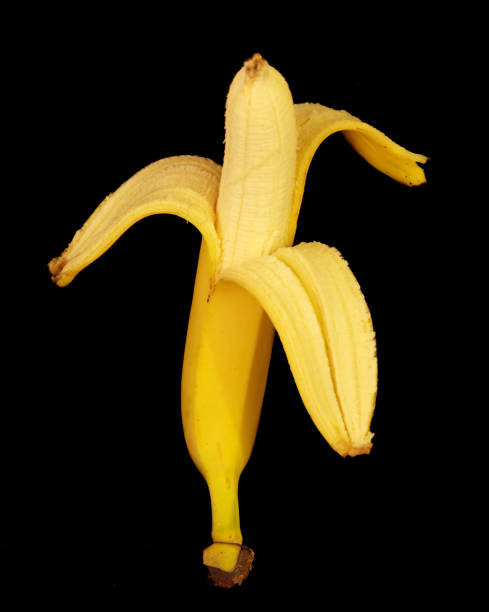 istock banana lies on a black background 1347852004