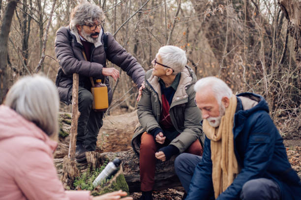 istock Group of seniors making coffee and having a break during hiking 1347852145