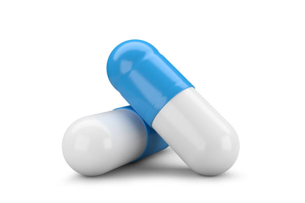 Red and blue pill representing a critical choice or dilemma. A medical and business metaphor for decision, strategy, and future alternatives isolated on white background with clipping path.