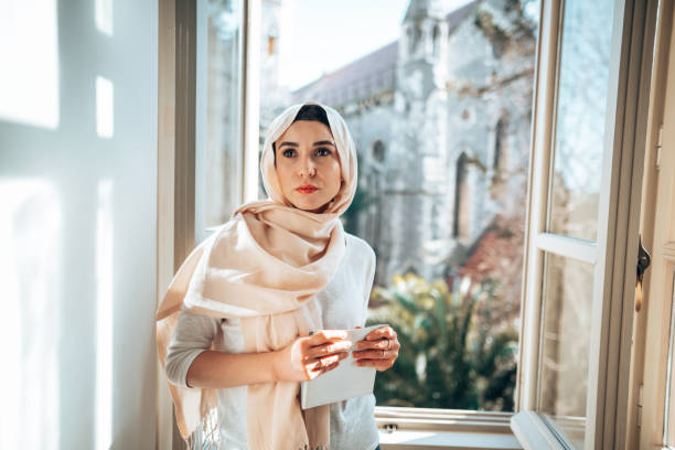 istock muslim woman at the window posing serious 1347853983
