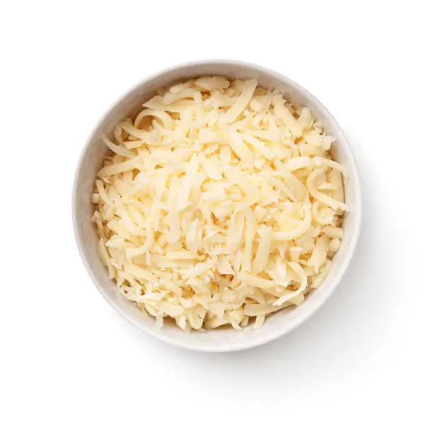 Grated gouda cheese in white bowl isolated on white background. Top view