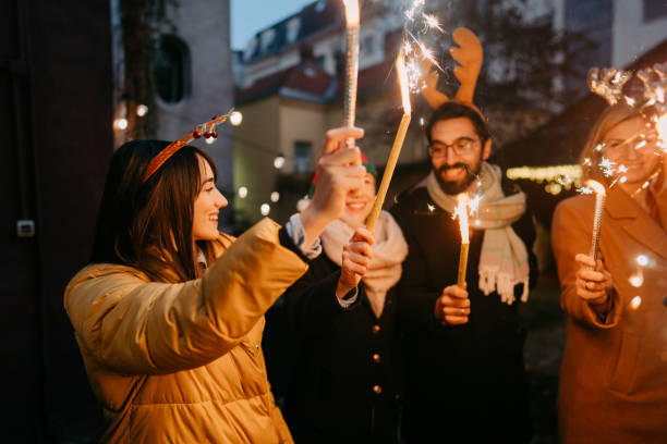istock Smiling friends celebrating Christmas outdoors 1347856431