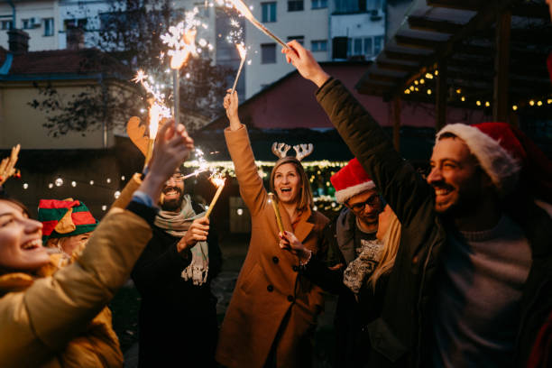 istock Smiling friends celebrating Christmas outdoors 1347856476