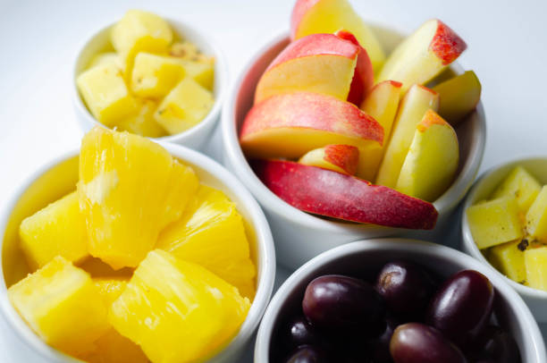 Bowl with Fruit salad on a granite countertop seen from directly above
