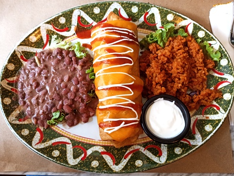 Traditional mexican burrito chimichanga dish serving with rice and bean in Istanbul turkey