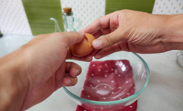 istock man breaking an egg to make a potato omelette 1347857346