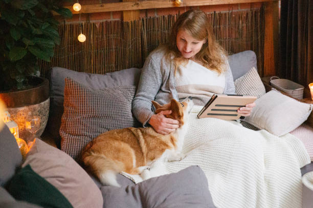 istock Woman relaxing on balcony and stroking her dog 1347858802