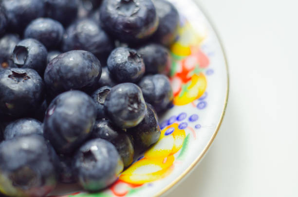 Closeup on fresh and ripe blueberries on a white background