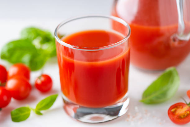 istock Tomato juice in glass closeup view 1347859277