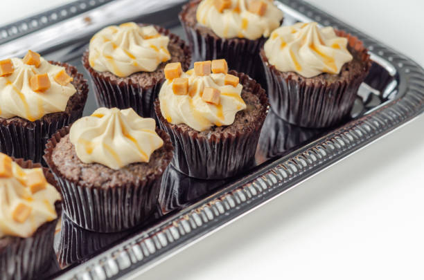 istock Salted caramel cupcakes, tempting little chocolate cupcakes with a baileys flavour frosting and caramel drizzle 1347863741